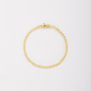 Overhead view of a gold-tone bracelet in a closed circle, showing the sides of the stone settings and clasp.